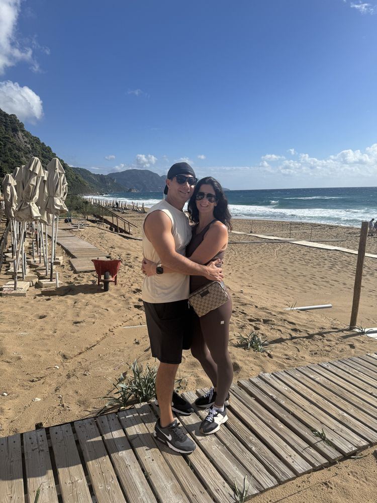 Rob and Nadine on a boardwalk at a Greek beach